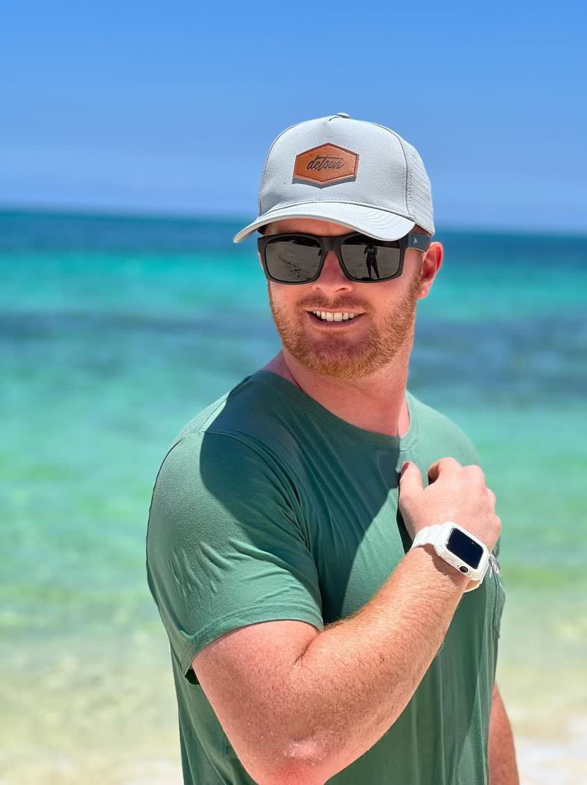 Snowboarder carving through powder in snowy terrain.