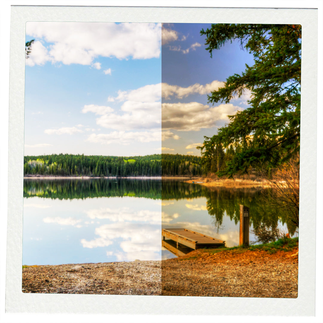 Lake reflection with a small dock and clear blue sky.