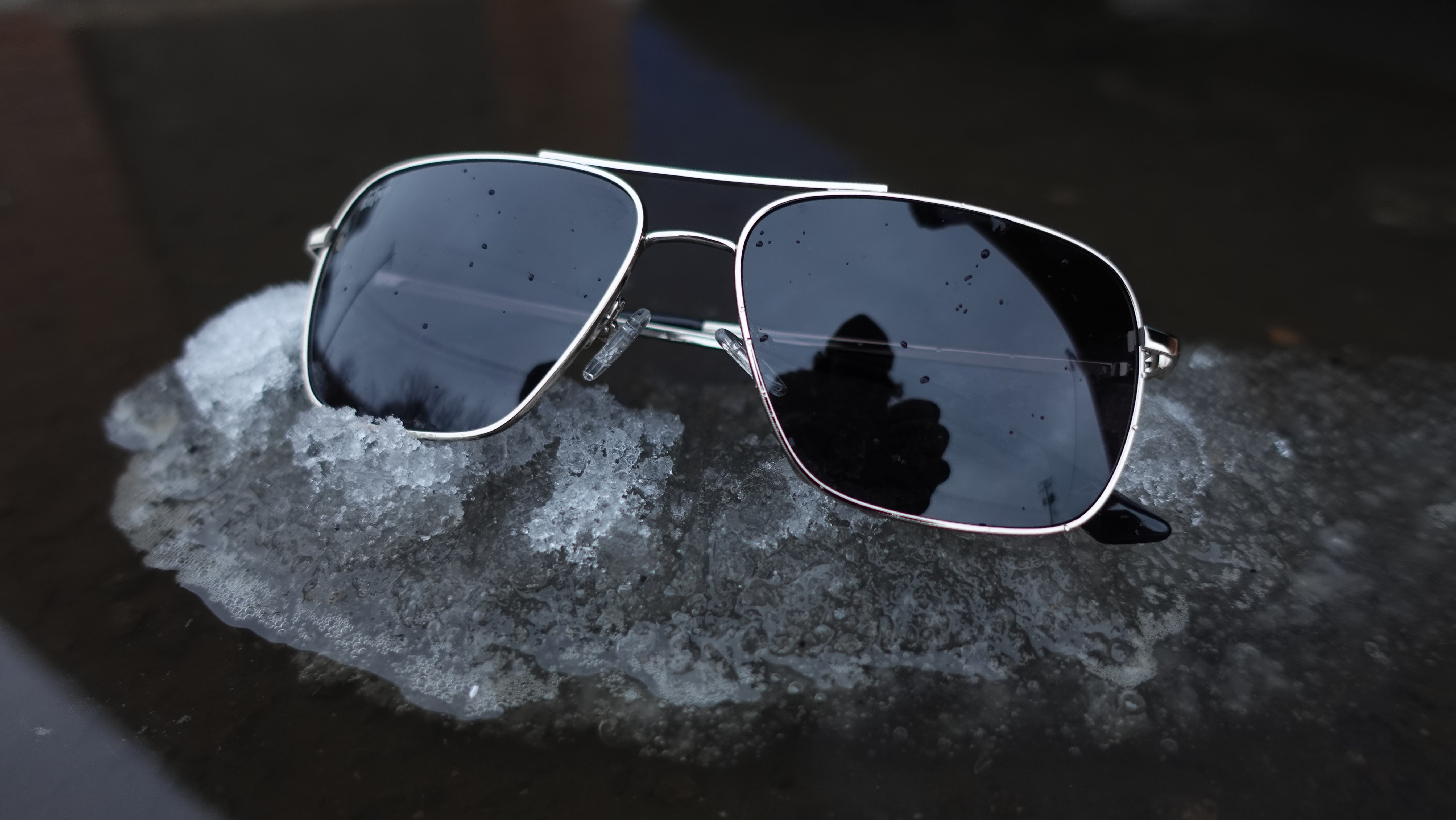 Snowboarder carving through powder in snowy terrain.