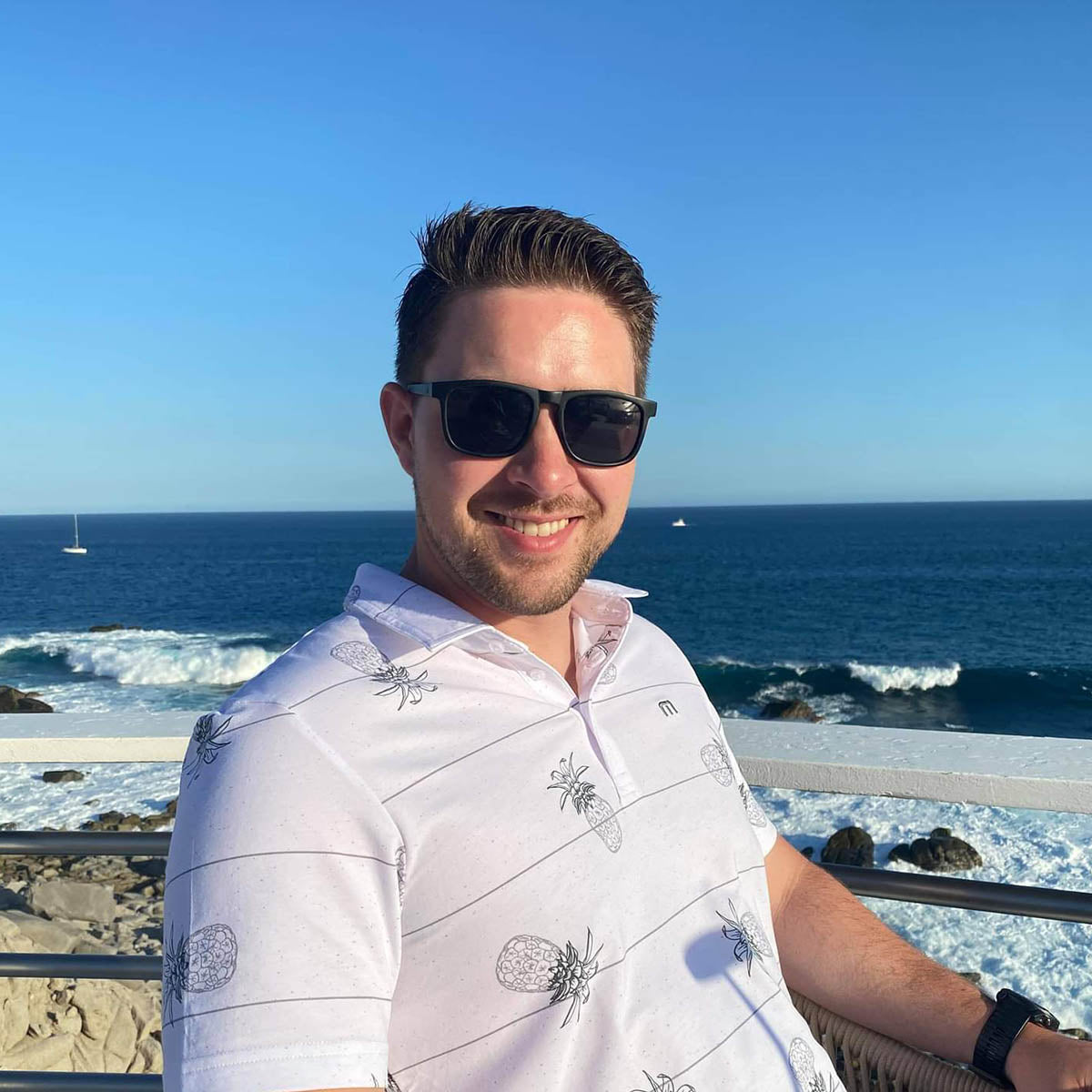 Snowboarder carving through powder in snowy terrain.