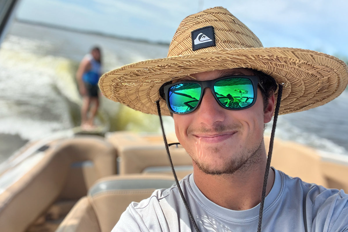 Snowboarder carving through powder in snowy terrain.