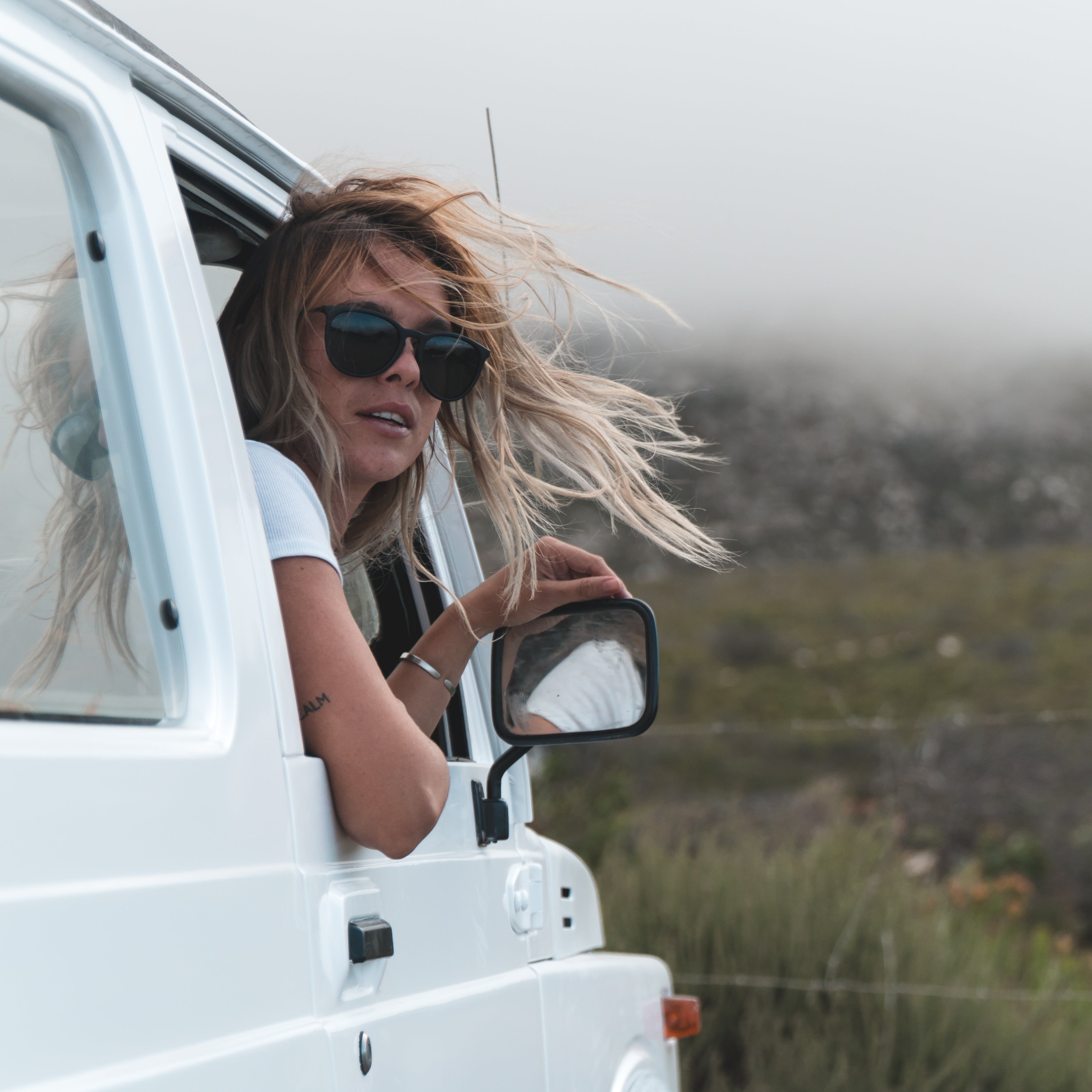 Snowboarder carving through powder in snowy terrain.