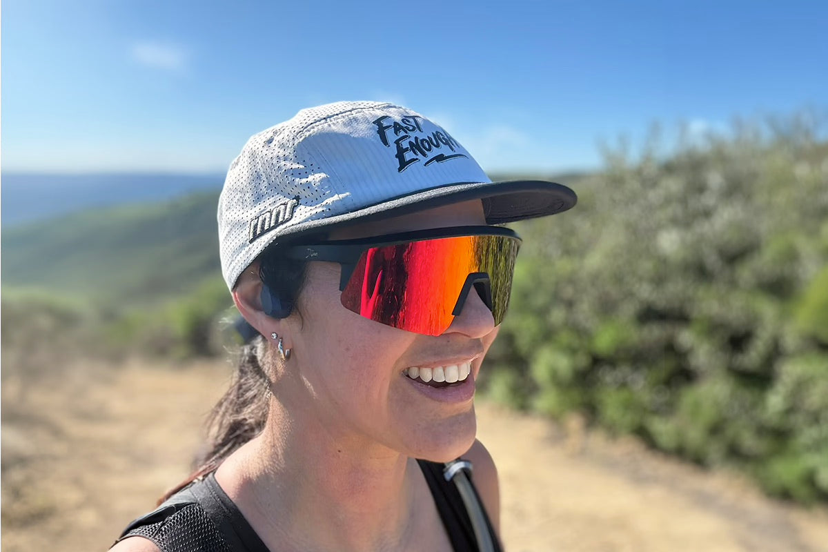 Snowboarder carving through powder in snowy terrain.