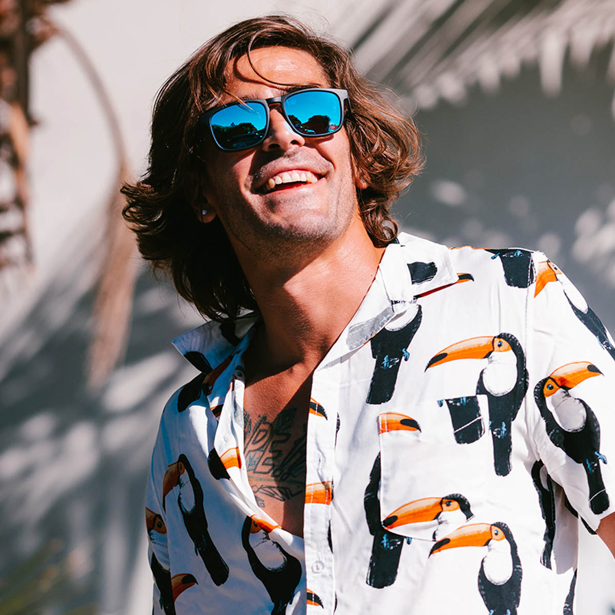 Snowboarder carving through powder in snowy terrain.