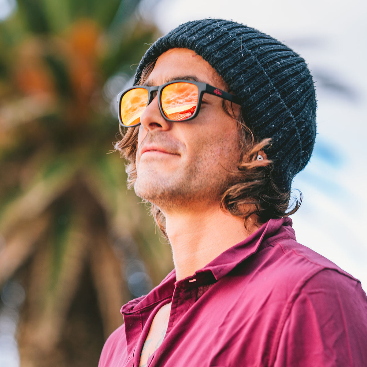 Snowboarder carving through powder in snowy terrain.
